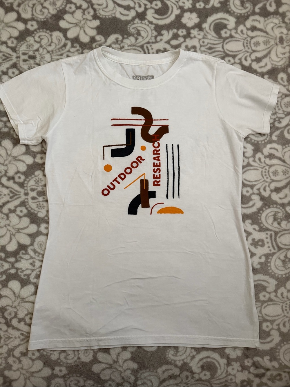 Outdoor Research Organic Cotton White Tee with Brown, Orange & Black Graphic
